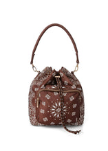 Load image into Gallery viewer, Walnut brown bandana print convertible bucket bag with drawstring closure and adjustable straps that can be worn as a backpack, shoulder bag, or crossbody bag.
