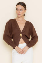 Load image into Gallery viewer, Woman wearing a brown cropped cardigan with a gold button on a beige background
