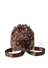 Load image into Gallery viewer, Walnut brown bandana print convertible bucket bag with drawstring closure and adjustable straps that can be worn as a backpack, shoulder bag, or crossbody bag.
