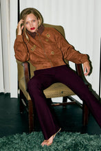 Load image into Gallery viewer, Woman sitting in a chair wearing a brown jacket with crystal embellised details and dark pants.
