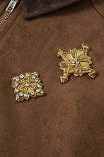 Load image into Gallery viewer, Two gold star-shaped brooches on a brown fabric suede jacket.

