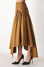 Load image into Gallery viewer, Caramel brown cotton midi skirt with a shirred waist, gathered full silhouette and dramatic asymmetrical draped hem.
