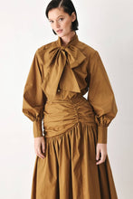 Load image into Gallery viewer, Caramel brown cotton midi skirt with a shirred waist, gathered full silhouette and dramatic asymmetrical draped hem.
