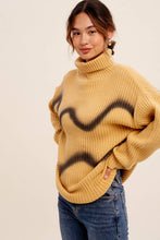 Load image into Gallery viewer, Woman wearing a mustard yellow sweater with black abstract patterns on a beige background

