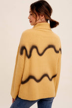 Load image into Gallery viewer, Person wearing a mustard yellow sweater with black wavy pattern on a beige background
