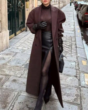 Load image into Gallery viewer, Person wearing a long brown coat on a city street.
