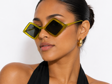 Load image into Gallery viewer, Close-up of chartreuse diamond sunglasses showing the angular frame and tinted lenses.
