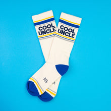 Load image into Gallery viewer, Cream crew socks with blue heel and toe featuring “Cool Uncle” text and striped accents.
