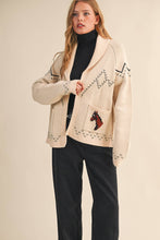 Load image into Gallery viewer, Woman wearing a beige cardigan with a horse design on a plain background
