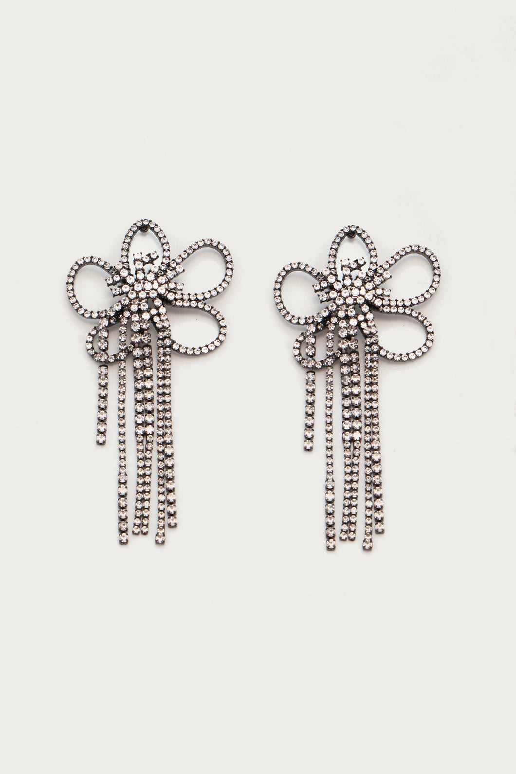 Introducing our Daisy Shimmer Earrings – a captivating blend of elegance and playfulness. These stunning statement earrings are meticulously crafted with glistening crystals, delicately forming the shape of a radiant flower. The lightweight design ensures comfort without compromising on style, making them the perfect accessory for any occasion. 