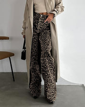 Load image into Gallery viewer, Unleash your wild side with our Retro Streetwear Leopard Print Trousers. Made from 100% cotton, these low-rise denim pants deliver bold style with a nod to classic streetwear vibes. The edgy leopard print makes them a statement piece, perfect for turning heads wherever you go.
