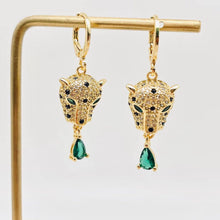Load image into Gallery viewer, Gold-plated leopard head huggie earrings with crystal details, green eyes and dangling emerald-green teardrop cubic zirconia stones.
