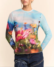 Load image into Gallery viewer, Sheer long sleeve mesh top with vibrant floral field print in soft focus colors, worn by a model.
