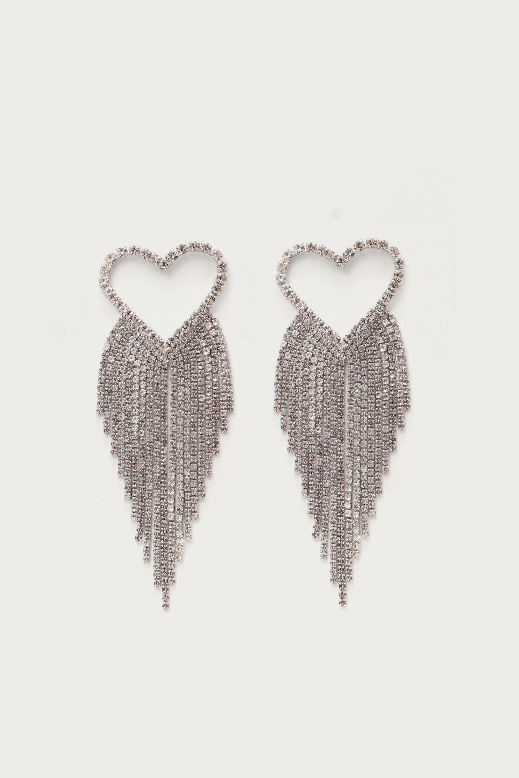 Elevate your style with our Silver Crystal Heart Tassel Earrings, the epitome of glamour and sophistication. These statement earrings effortlessly blend timeless elegance with contemporary flair, featuring a stunning heart-shaped crystal with delicate silver crystal chains. The intricate tassel design adds movement and allure, ensuring you stand out on any occasion. Make a bold statement and adorn yourself with these exquisite earrings.