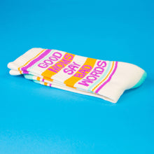 Load image into Gallery viewer, Cream crew socks with teal heel and toe featuring “Good Moms Say Bad Words” text and colorful stripe accents.
