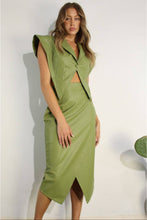 Load image into Gallery viewer, Woman wearing a green leather Glam Expressway skirt with a matching jacket against a white background
