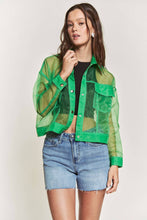 Load image into Gallery viewer, Woman wearing a green sheer jacket over a black top and blue shorts on a white background
