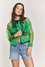Load image into Gallery viewer, Woman wearing a green sheer jacket over a black top and denim shorts on a white background
