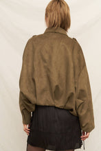 Load image into Gallery viewer, Person wearing a green suede jacket and black skirt against a white background
