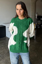 Load image into Gallery viewer, Wrap yourself in cozy style with this Green &amp; Cream Color Block Knit Sweater. Designed with a relaxed fit and a classic crew neck, it features a soft, medium-weight cable knit that adds texture and warmth. The all-over color block pattern offers a modern twist on a timeless piece, making it an effortless addition to any casual outfit. True to size, this sweater is perfect for layering or wearing solo for a chic, laid-back look.
