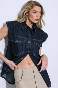 Introducing our stylish denim top, a versatile wardrobe essential. This trendy piece boasts a classic shirt collar and a convenient snap button-down front, making it both chic and easy to wear. The sleeveless design adds a touch of modern flair, perfect for warmer days or layering with your favorite jacket. Complete with front pockets for added functionality and style, this denim top effortlessly combines fashion and comfort for a timeless look.