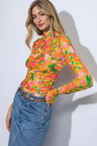 Designed to make a statement, this Floral Mesh Top boasts a unique combination of floral patterns on a breathable mesh fabric. The long sleeves provide a touch of grace, making it the perfect choice for both casual events and special occasions. Embrace the allure of this versatile top that effortlessly transitions from day to night.