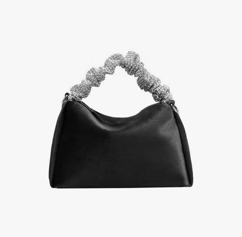 Upgrade your accessory game with the Crystal Top Handle Black Velvet Bag. This gorgeous evening bag is a statement piece designed to keep you stylish and organized throughout the holiday season. Our crystal handle velvet bag effortlessly combines fashion and function, making it your ideal companion for any occasion.
