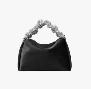 Upgrade your accessory game with the Crystal Top Handle Black Velvet Bag. This gorgeous evening bag is a statement piece designed to keep you stylish and organized throughout the holiday season. Our crystal handle velvet bag effortlessly combines fashion and function, making it your ideal companion for any occasion.