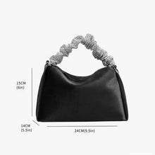 Load image into Gallery viewer, Upgrade your accessory game with the Crystal Top Handle Black Velvet Bag. This gorgeous evening bag is a statement piece designed to keep you stylish and organized throughout the holiday season. Our crystal handle velvet bag effortlessly combines fashion and function, making it your ideal companion for any occasion.
