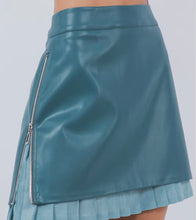 Load image into Gallery viewer, Make a statement this season with our gorgeous blue vegan leather mini skirt. With its beautiful and unique zipper detail and inner pleats, the details of this skirt are both stylish and functional. The sweet, feminine pleats also add to its charm while creating a flattering silhouette. Wear our Blue Vegan Leather Skirt when you need something fashion forward or business casual.
