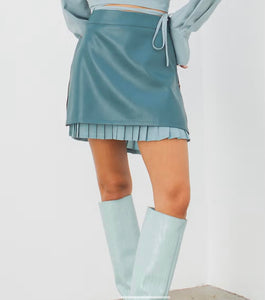 Make a statement this season with our gorgeous blue vegan leather mini skirt. With its beautiful and unique zipper detail and inner pleats, the details of this skirt are both stylish and functional. The sweet, feminine pleats also add to its charm while creating a flattering silhouette. Wear our Blue Vegan Leather Skirt when you need something fashion forward or business casual.