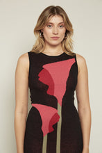 Load image into Gallery viewer, The Lily Sweater Dress is a chic sleeveless black knit dress featuring a bold red lily on the front. Made entirely from recycled fabric and imported with care, this dress blends eco-consciousness with effortless style. Perfect for any occasion, it’s a statement piece that keeps sustainability in focus.
