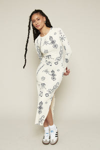 The Doodle Print Black &amp; White Maxi Dress is a stunning long-sleeved, fitted dress that effortlessly combines elegance with an edge. Featuring a chic slit and a striking black-and-white scribble print, this maxi dress is made entirely from recycled fabric, offering both style and sustainability. Perfect for making a bold statement at any event.