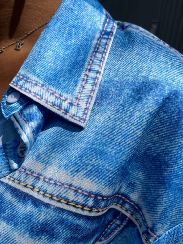 Close-up of blue denim fabric with stitching details