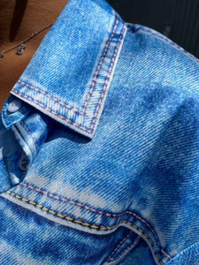 Close-up of blue denim fabric with stitching details