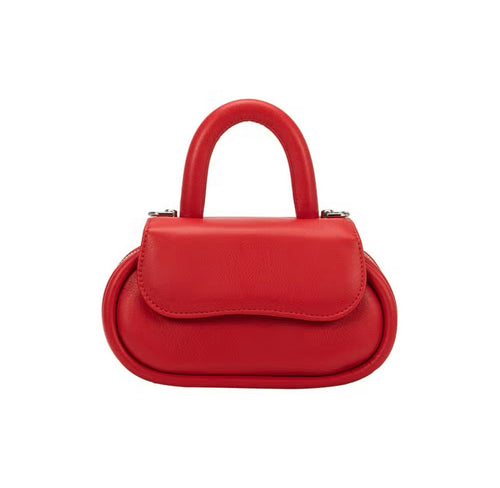 Meet our Cherry Red Structured Bag, the epitome of fashion and sustainability. This small round-top handle bag, made from recycled vegan leather, is your eco-conscious style statement. Wear it comfortably as a crossbody bag using the adjustable strap for hands-free convenience.