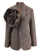 Load image into Gallery viewer, Introducing the Tweed Blazer with 3D Flower—a chic blend of classic and bold! Crafted from luxurious twill woolen fabric, this single-button blazer features a notched lapel and a stunning oversized detachable 3D flower that adds a dramatic flair. Perfect for making a statement, it combines sophistication and uniqueness, allowing you to switch up your look with ease. Dress it up for work or a night out—this piece guarantees to turn heads! Available now in women&#39;s sizes.
