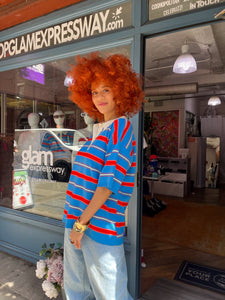 Short-sleeve multicolored striped polo shirt with red, blue, and cream stripes, soft knit fabric, and contrasting cream collar - stylish and comfortable women’s preppy polo top, perfect for summer outfits, easy casual wear, or elevated everyday fashion; available now at Glam Expressway.