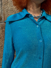 Load image into Gallery viewer, Close-up of a blue textured fabric with buttons on a brown surface
