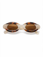 Load image into Gallery viewer, Oval sunglasses with marbled tortoise and cream frame and brown lenses shown on model and product background.
