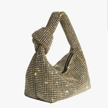 Load image into Gallery viewer, Add some sparkle to your holiday look with the Gold Crystal Evening Bag. Made with crystals and a top handle, this stylish bag features a shiny, bling-inspired silhouette that is sure to add some extra glamour to any occasion.
