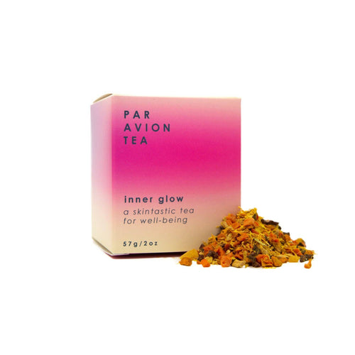 Par Avion Tea 'Inner Glow' packaging with tea leaves on a white background