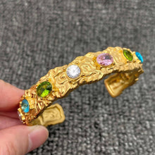 Load image into Gallery viewer, Hammered 18K gold-plated stainless steel cuff bracelet featuring multicolor pink, green, blue and clear zircon stones.
