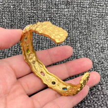 Load image into Gallery viewer, Hammered 18K gold-plated stainless steel cuff bracelet featuring multicolor pink, green, blue and clear zircon stones.
