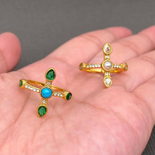 Load image into Gallery viewer, 18K gold-plated cross statement ring featuring green stones, clear cubic zirconia accents and a turquoise-blue center stone.
