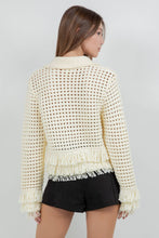 Load image into Gallery viewer, Lemon yellow fringe knit cotton cardigan sweater with button front, open knit texture, and fringe trim at hem and cuffs worn with black shorts.
