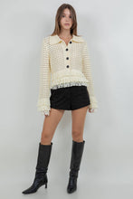 Load image into Gallery viewer, Lemon yellow fringe knit cotton cardigan sweater with button front, open knit texture, and fringe trim at hem and cuffs worn with black shorts.
