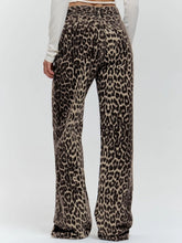 Load image into Gallery viewer, Unleash your wild side with our Retro Streetwear Leopard Print Trousers. Made from 100% cotton, these low-rise denim pants deliver bold style with a nod to classic streetwear vibes. The edgy leopard print makes them a statement piece, perfect for turning heads wherever you go.
