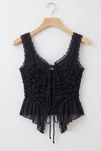Load image into Gallery viewer, Black sleeveless ruched lace tie top featuring intricate floral ruching, adjustable front ties and feminine peplum hem on white background.
