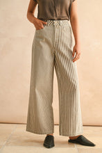 Load image into Gallery viewer, Person wearing beige wide-leg pants with white stripes against a beige background
